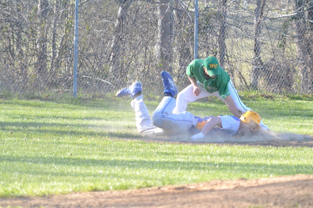 After straying too far off of third base, Manchester's Jared Stricklett is tagged out attempting to get back to the base.