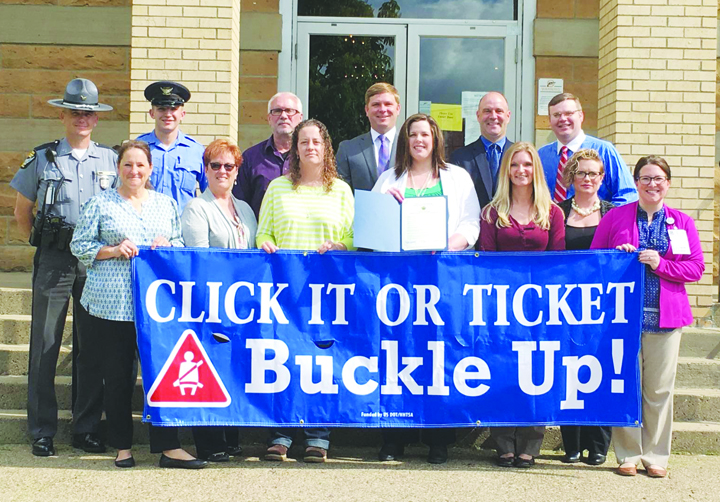 The Adams County Commissioners met with members of the Adams County Safe Communities Coalition recently and proclaimed May 23 to June 5 as the “Click It or Ticket” Mobilization in Adams County and urge all citizens to always wear seat belts when driving or riding on our roadways. Pictured above: Front row, from left, Holly Johnson, Adams County Economic and Community Development Director; Debbie Ryan, Adams County Safe Communities Coordinator,; Heather Roush, Adams Brown Early Head Start; Sarah Hood, Program Director, The Counseling Center; Amanda Fraley, Fiscal Agent, Adams County Safe Communities grant; Heather Hoop, HR Director, Adams County Regional Medical Center; and Erin Meade, HR/Community Relations Assistant, Adams County Regional Medical Center; Back row, from left, Trooper Shannon Utter, OSP-Georgetown Post, Jordan Haggerty, OSP Cadet Intern; Mike Hughes, Resource Manager, Adams County Engineer’s Office; Commissioner Paul Worley; Commissioner Brian Baldridge; and Commissioner Stephen Caraway.