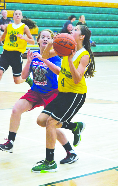 With the left hand, North Adams eighth grader Karissa Buttelwerth looks to the rim as the Lady Devils battled Northwest in action on June 8 in Seaman.