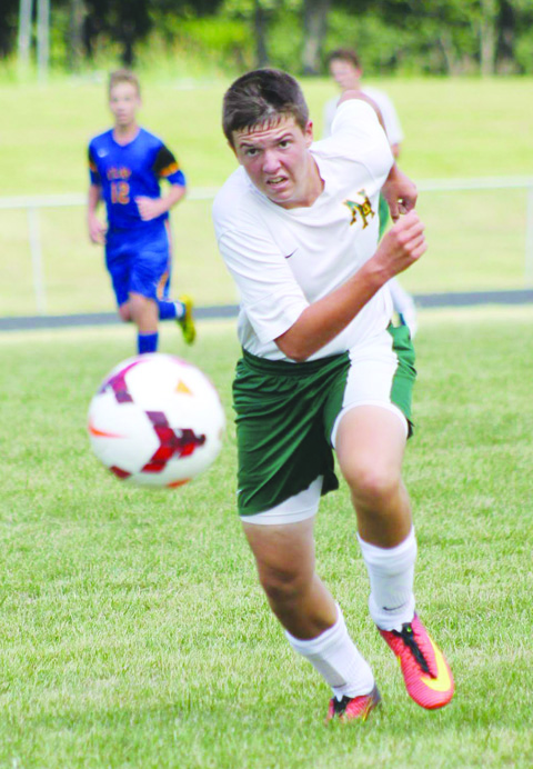 Sophomore Ethan Campbell keeps his eye on the ball here in action from Saturday’s win over Clay.  Campbell scored one of the goals for the Green Devils in a 7-2 win.