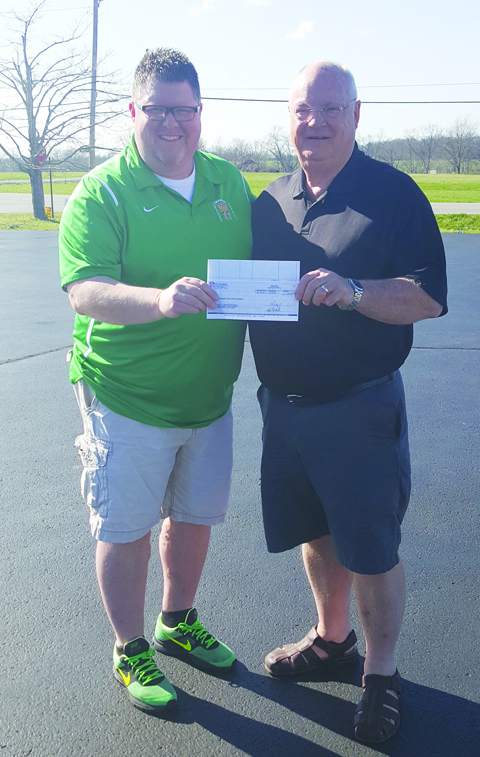 Scott McFarland, left, receives the check from the Bengals and the NFL Foundation from grant writer Ed Salsbury.