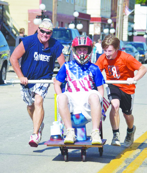 A different kind of race headed down 2nd Street in Manchester on Saturday evening, this one appropriately called “The Toilet Bowl Race.”  Photo by Michelle Bilyeu
