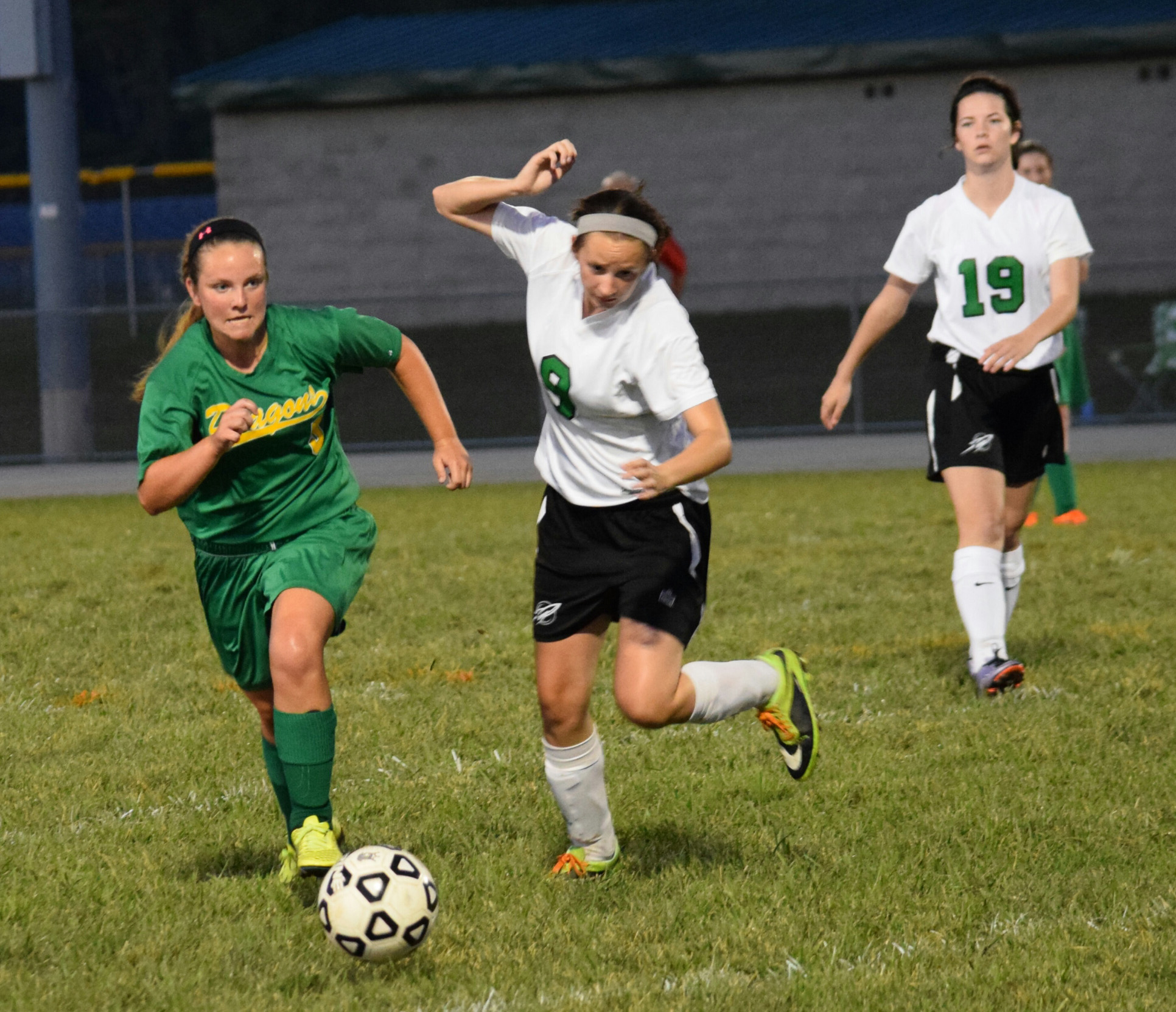 West Union’s Shannon Runyan, left,  chases down the ball with Fayetteville players in pursuit during the Lady Dragons’ 3-1 win on Monday night.