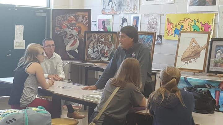 Artist Gary Blevins, center, speaks to a freshman art class at West Union High School on Sept. 21.