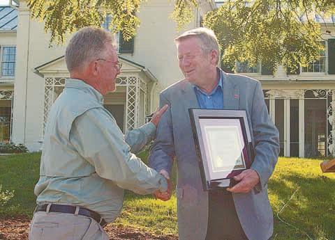 Tom Cross, left, accepts the ODNR Cardinal Award from ODNR Director James Zehringer.