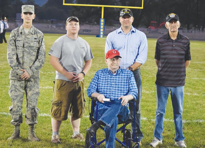 During pregame ceramonies before their Sept. 23 game with Jefferson Township, Manchester High School took time to honor these veterans in attendance and make them part of the coin flip at midfield.  Pictured, from left, J.D. Stamper (Air Force), Tyler Grooms (U.S. Army), Dallas Breeze (U.S. Navy), Paul Worley (U.S. Army), and James Breeze (Air Force)  Photo by Mark Carpenter