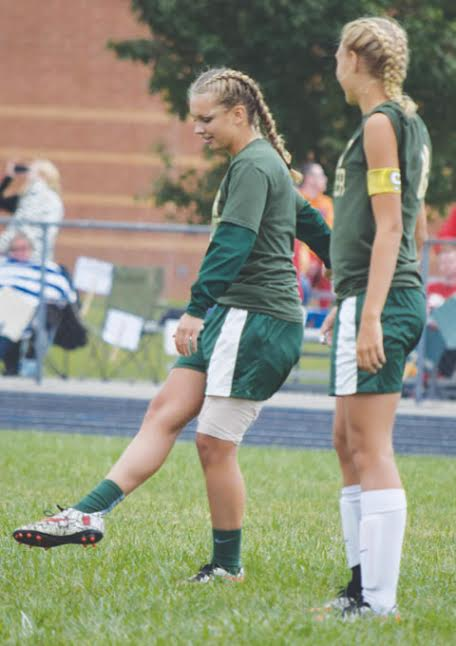 North Adams senior Jordyn Kell, left, out for the season with an injury, opened last Saturday’s game with a ceremonial kick off.