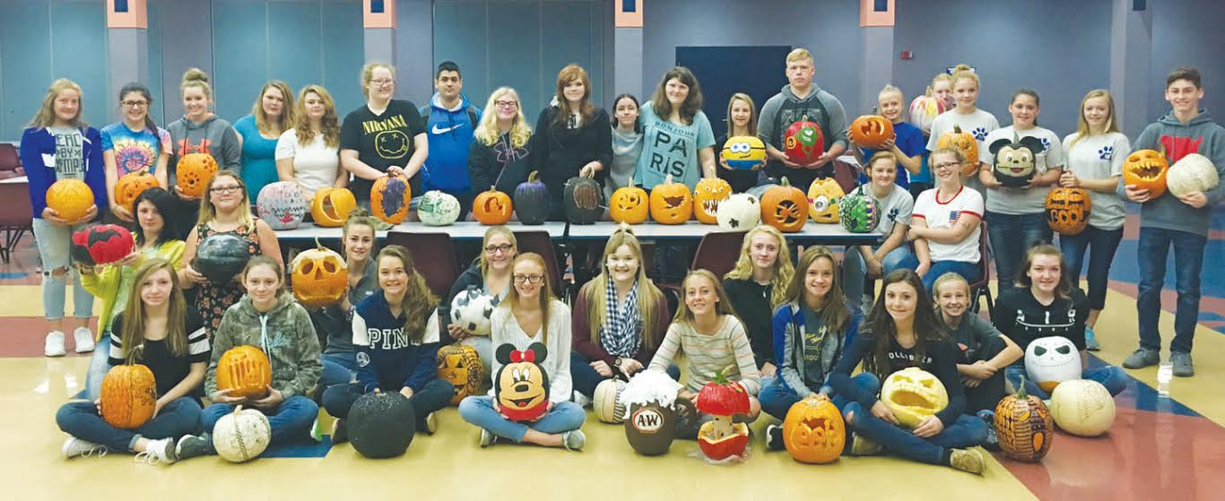 These students creatively represented Manchester Junior and Senior High School by painting and carving pumpkins for Woodland Altars (Southern Ohio's First Lighted Pumpkin Festival).  Students had the option to paint, design, or carve pumpkins. Students painted their pumpkins to look like their favorite cartoon or Disney characters or decorated their pumpkins with a variety of zentangle designs. Other students carved their pumpkins to look like scary monsters, or silhouettes of fairies, cats or various spooky words. Pictured: Front row, from left,  Andrea Parker, Autumn Parker, Abby McFarland, Katie Sandlin, Jade Rust, Xena Crummie, Taylor Young, Taylor Morrison, Billie Kinhalt, Jenna McClanahan, Tori Barlow, Kayden Francis and Madison Young;  Middle row, from left,  Jalyn Thacker, Grace Hackney, Vanessa Francis and Destiny Smith; Back row, from left,  Madison Jones, Madison Payne, Mackenzie Leadingham, Ashley Francis, Taylor Hanshaw, Ariann Alexander, Frank Santoriello, Taylor Ogden, Breanna O'Connell, Syliva Jernigan, Melanie Lawerence, Alyssa Grooms, Jacob Calvert, Jasmine Stanfield, Katelynn Swearingen, Gabby Baldwin, Brittany Francis, Sierra Shelton, and Nathaniel Peterson.