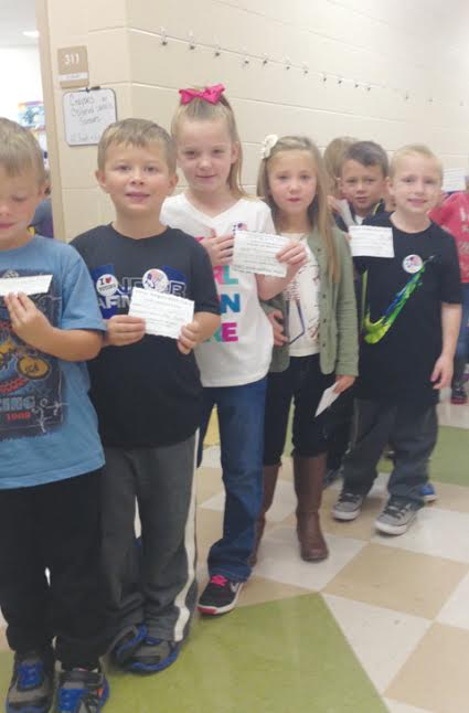 Pictured here are kindergarten students from Mrs. Karisa Miller's kindergarten class.  These students had just voted and are showing their identification card and voter sticker.