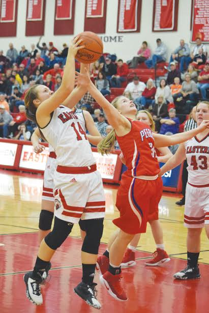 Peebles’ Baylee Justice, right, battles for a rebound with Eastern’s Morgan Reynolds in action from Monday night’s SHAC battle, won by the Lady Warriors 50-39.