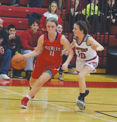 Peebles’ Matti Nichols looks for room around the corner against the defense of Eastern’s Camryn Pickerill during the second half of Tuesday night’s SHAC contest.